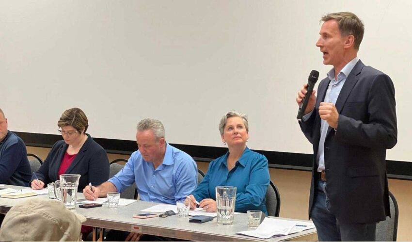 Addressing constituents at a public meeting in his South West Surrey constituency